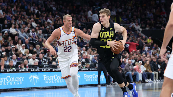 Nov 12, 2024; Salt Lake City, Utah, USA; Utah Jazz forward Lauri Markkanen (23) drives to the basket against Phoenix Suns center Mason Plumlee (22) during the fourth quarter at Delta Center. Mandatory Credit: Rob Gray-Imagn Images
