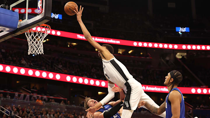 Feb 8, 2024; Orlando, Florida, USA;  Orlando Magic center Moritz Wagner (21) fouls San Antonio Spurs center Victor Wembanyama (1) during the second half at Kia Center. Mandatory Credit: Kim Klement Neitzel-Imagn Images