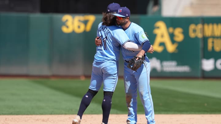 Jun 9, 2024; Oakland, California, USA; Toronto Blue Jays shortstop Bo Bichette (11) celebrates with third baseman Isiah Kiner-Falefa (right) after defeating the Oakland Athletics at Oakland-Alameda County Coliseum.