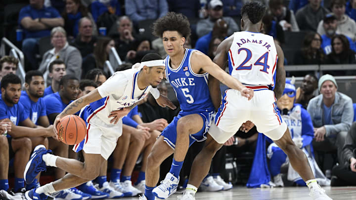 Nov 15, 2022; Indianapolis, Indiana, USA;  Kansas Jayhawks guard Dajuan Harris Jr. (3) drives the ball around Duke Blue Devils guard Tyrese Proctor (5) during the first half at Gainbridge Fieldhouse. Mandatory Credit: Marc Lebryk-Imagn Images