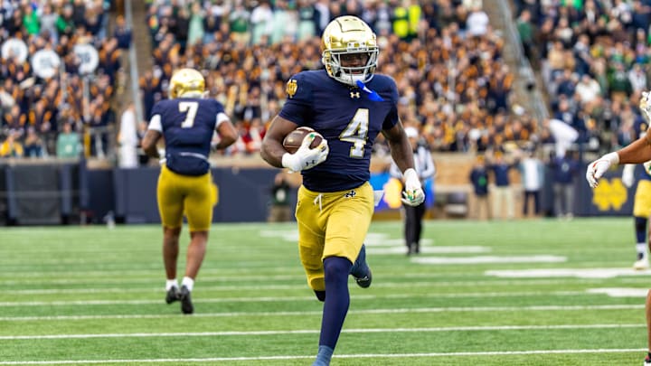 Nov 22, 2025; South Bend, Indiana, USA; Notre Dame Fighting Irish running back Jeremiyah Love (4) breaks loose for a touchdown run against the Syracuse Orange during the first half at Notre Dame Stadium. 