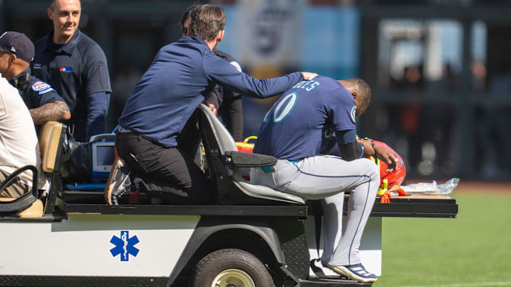 Seattle Mariners right fielder Victor Robles (right) is carted off the field during a game against the San Francisco Giants on April 6 at Oracle Park. Seattle Mariners right fielder Victor Robles (right) is carted off the field during a game against the San Francisco Giants on April 6 at Oracle Park.