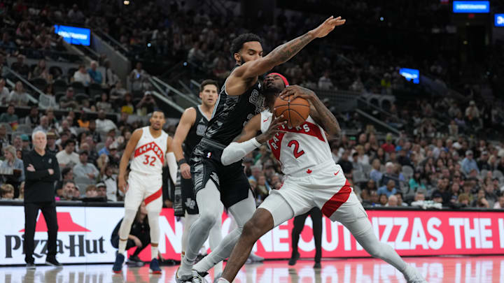Nov 5, 2023; San Antonio, Texas, USA; San Antonio Spurs forward Julian Champagnie (30) reaches over Toronto Raptors forward Jalen McDaniels (2) in the first half at the Frost Bank Center. Nov 5, 2023; San Antonio, Texas, USA; San Antonio Spurs forward Julian Champagnie (30) reaches over Toronto Raptors forward Jalen McDaniels (2) in the first half at the Frost Bank Center.