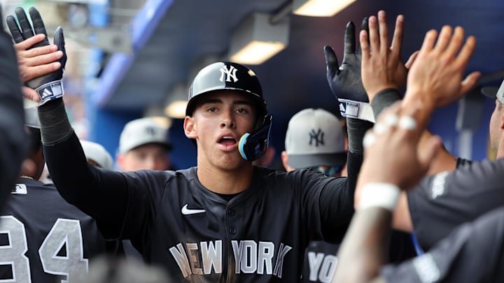 Feb 22, 2025; Dunedin, Florida, USA; New York Yankees shortstop George Lombard Jr. (96) is congratulated after he scored a run during the sixth inning against the Toronto Blue Jays at TD Ballpark. Mandatory Credit: Kim Klement Neitzel-Imagn Images Feb 22, 2025; Dunedin, Florida, USA; New York Yankees shortstop George Lombard Jr. (96) is congratulated after he scored a run during the sixth inning against the Toronto Blue Jays at TD Ballpark. Mandatory Credit: Kim Klement Neitzel-Imagn Images