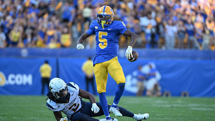 Sep 14, 2024; Pittsburgh, Pennsylvania, USA; Pittsburgh Panthers wide receiver Raphael Williams Jr. (5) celebrates after a catch against West Virginia Mountaineers safety Aubrey Burks (2) during the second quarter at Acrisure Stadium. Mandatory Credit: Barry Reeger-Image Images