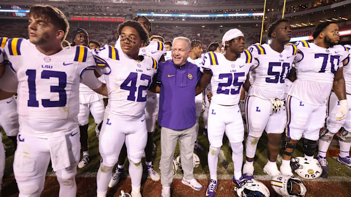 Oct 19, 2024; Fayetteville, Arkansas, USA; LSU Tigers quarterback Garrett Nussmeier (13) along with teammates and head coach Brian Kelly sing the LSU alma mater after a game against the Arkansas Razorbacks at Donald W. Reynolds Razorback Stadium. LSU won 34-10. Mandatory Credit: Nelson Chenault-Imagn Images