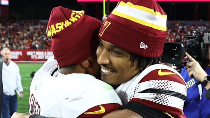 Jan 12, 2025; Tampa, Florida, USA; Washington Commanders quarterback Jayden Daniels (5) celebrates with linebacker Bobby Wagner (54) after winning a NFC wild card playoff against the Tampa Bay Buccaneers at Raymond James Stadium. Mandatory Credit: Kim Klement Neitzel-Imagn Images
