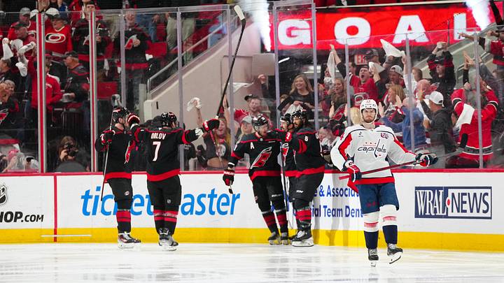May 12, 2025; Raleigh, North Carolina, USA; Carolina Hurricanes center Seth Jarvis (24) celebrates his goal with defenseman Jalen Chatfield (5), defenseman Dmitry Orlov (7), and right wing Andrei Svechnikov (37) against the Washington Capitals during the second period in game four of the second round of the 2025 Stanley Cup Playoffs at Lenovo Center. Mandatory Credit: James Guillory-Imagn Images