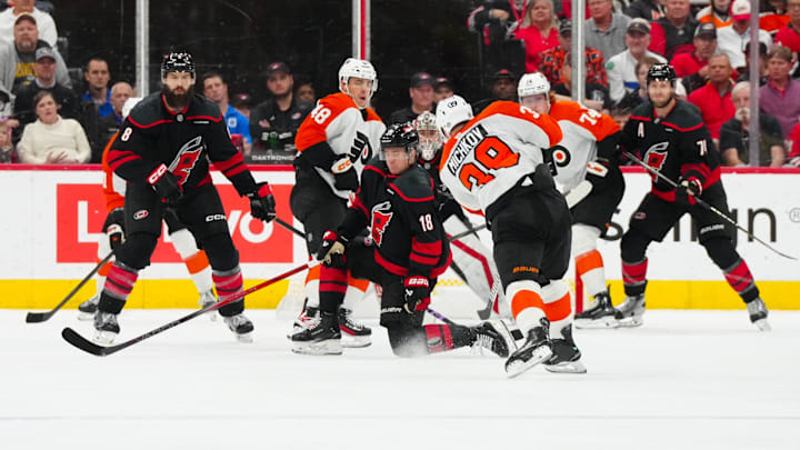 Nov 5, 2024; Raleigh, North Carolina, USA;  Philadelphia Flyers right wing Matvei Michkov (39) takes a shot past Carolina Hurricanes center Jack Drury (18) during the first period at Lenovo Center. 