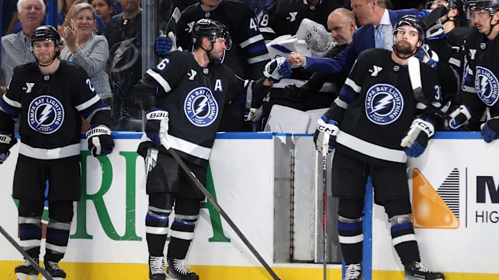 Oct 25, 2025; Tampa, Florida, USA; Tampa Bay Lightning right wing Nikita Kucherov (86) is congratulated by head coach Jon Cooper after he got an assist and his 1,000 career point against the Anaheim Ducks during the second period at Benchmark International Arena. Mandatory Credit: Kim Klement Neitzel-Imagn Images