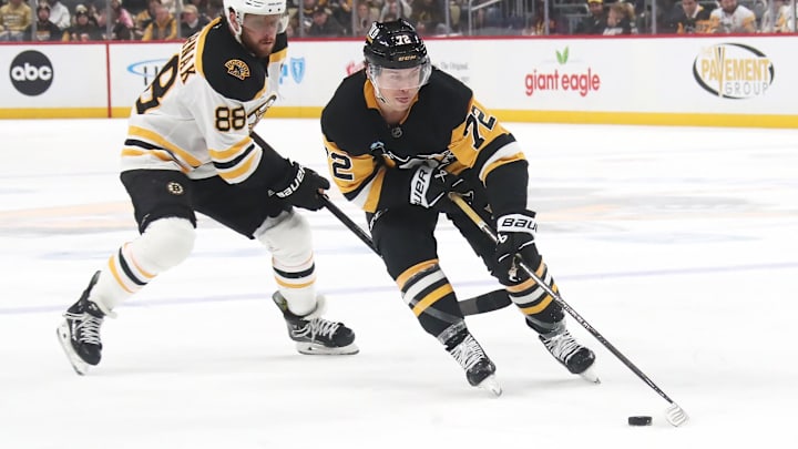 Mar 1, 2025; Pittsburgh, Pennsylvania, USA;  Pittsburgh Penguins left wing Anthony Beauvillier (72) moves the puck against Boston Bruins right wing David Pastrnak (88) during the third period at PPG Paints Arena. Mandatory Credit: Charles LeClaire-Imagn Images