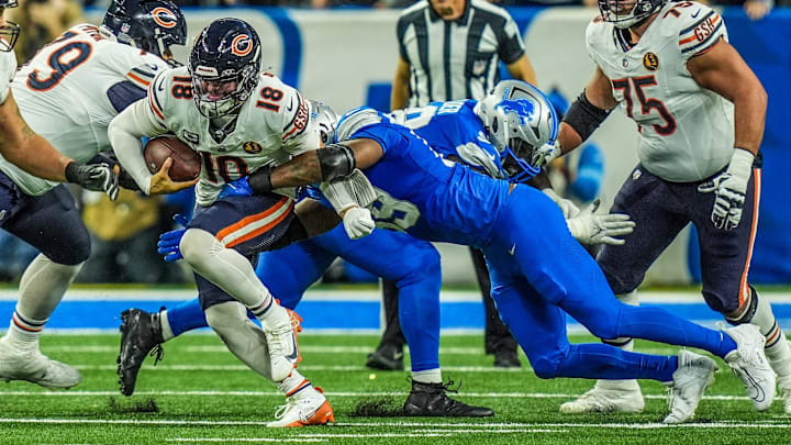 Chicago Bears quarterback Caleb Williams (18) is sacked by Detroit Lions defensive end Za'Darius Smith (99).