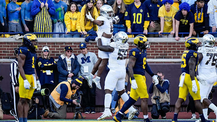 Oregon running back Noah Whittington is lifted by offensive lineman Marcus Harper II to celebrate a touchdown against Michigan during the first half at Michigan Stadium in Ann Arbor on Saturday, Nov. 2, 2024.