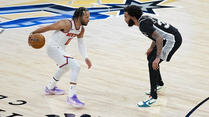New York Knicks guard Jalen Brunson (11) looks to move the ball past San Antonio Spurs forward Julian Champagnie (30) during the fourth quarter during game one of the 2026 NBA Finals at Frost Bank Center.