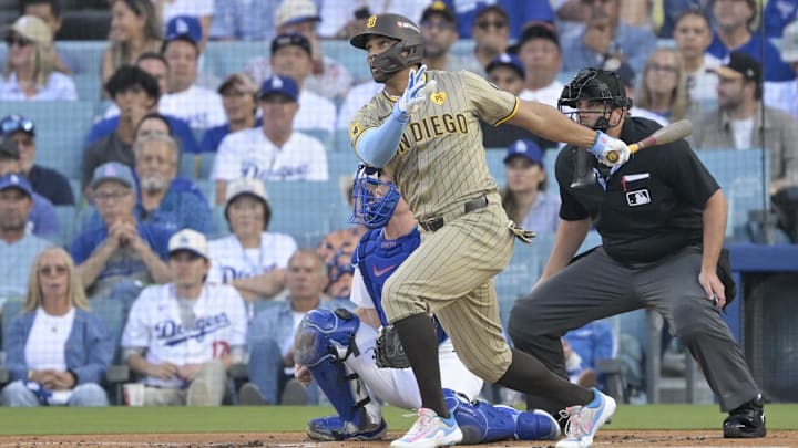 Oct 5, 2024; Los Angeles, California, USA; San Diego Padres shortstop Xander Bogaerts (2) scores a single in the first inning against the Los Angeles Dodgers during game one of the NLDS for the 2024 MLB Playoffs at Dodger Stadium. Mandatory Credit: Jayne Kamin-Oncea-Imagn Images
