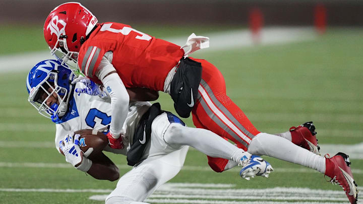 McCallie's Loia Valade (13) is tackled by Baylor's Jamyan Theodore (5) during the TSSAA Division II-AAA high school football Bluecross Bowl on Thursday, Dec. 5, 2024, in Chattanooga, Tenn. McCallie's Loia Valade (13) is tackled by Baylor's Jamyan Theodore (5) during the TSSAA Division II-AAA high school football Bluecross Bowl on Thursday, Dec. 5, 2024, in Chattanooga, Tenn.