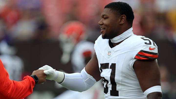 Cleveland Browns defensive tackle Mike Hall Jr. (51) shakes hands with a coach before an NFL preseason football game at Cleveland Browns Stadium, Saturday, Aug. 17, 2024, in Cleveland, Ohio.