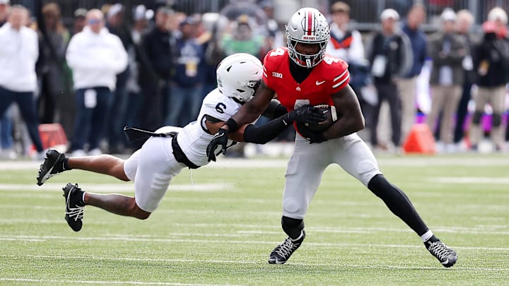 Ohio State Buckeyes wide receiver Jeremiah Smith (4) runs with the ball as Penn State Nittany Lions safety Zakee Wheatley (6) makes the tackle Ohio State Buckeyes wide receiver Jeremiah Smith (4) runs with the ball as Penn State Nittany Lions safety Zakee Wheatley (6) makes the tackle