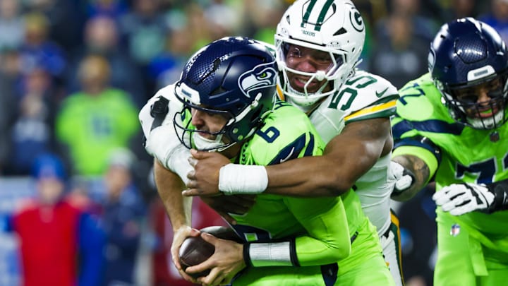 Dec 15, 2024; Seattle, Washington, USA; Green Bay Packers defensive end Kingsley Enagbare (55) sacks Seattle Seahawks quarterback Sam Howell (6) during the third quarter at Lumen Field. Mandatory Credit: Joe Nicholson-Imagn Images
