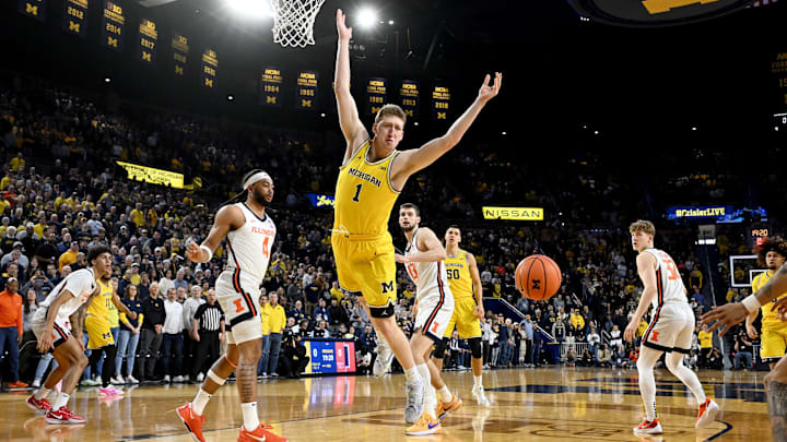 Mar 2, 2025; Ann Arbor, Michigan, USA;  Michigan Wolverines center Danny Wolf (1) loses control of the ball while driving to the basket against Illinois Fighting Illini guard Kylan Boswell (4) in the first half at Crisler Center. Mandatory Credit: Lon Horwedel-Imagn Images