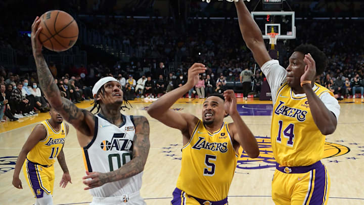 Jan 17, 2022; Los Angeles, California, USA; Los Angeles Lakers guard Talen Horton-Tucker (5) and Los Angeles Lakers forward Stanley Johnson (14) defend Utah Jazz guard Jordan Clarkson (00) as he goes to the basket in the second half of the game at Crypto.com Arena. Mandatory Credit: Jayne Kamin-Oncea-Imagn Images