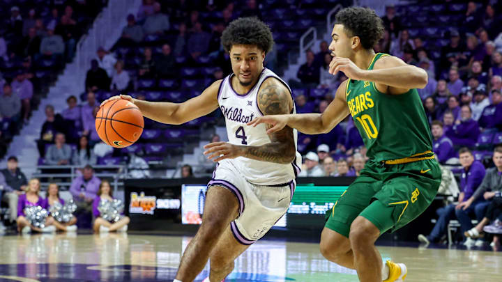 Feb 17, 2026; Manhattan, Kansas, USA; Kansas State Wildcats guard P.J. Haggerty (4) is guarded by Baylor Bears guard Isaac Williams IV (10) during the first half at Bramlage Coliseum. 