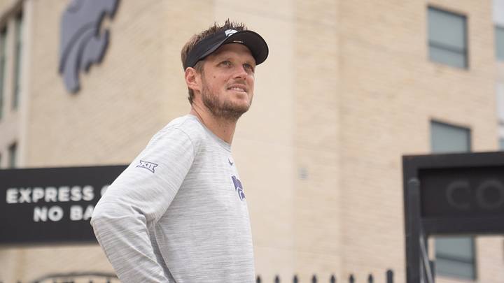 Kansas State coach Collin Klein waits for players to walk towards the indoor facility during practice at Kansas State University on Aug. 18, 2026. Kansas State coach Collin Klein waits for players to walk towards the indoor facility during practice at Kansas State University on Aug. 18, 2026.