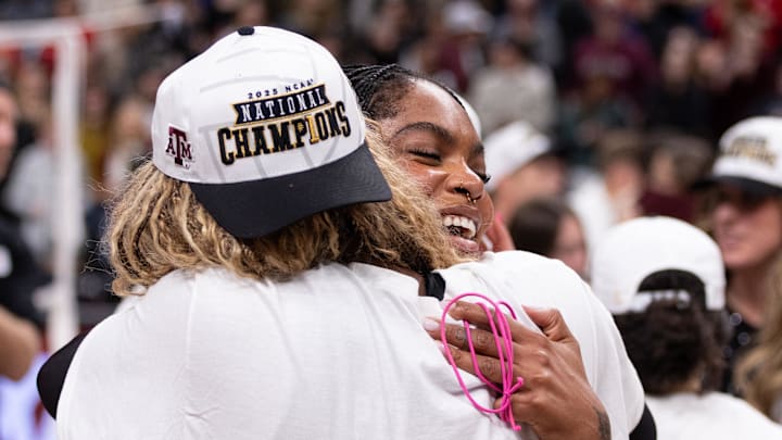 Dec 21, 2025; Kansas City, MO, USA; Texas A&M Aggies middle blocker Ifenna Cos-Okpalla (1) hugs middle blocker Morgan Perkins (21) following their team’s win over the Kentucky Wildcats in the 2025 NCAA Women’s Volleyball Championship at T-Mobile Center.Mandatory Credit: Kylie Graham-Imagn Images