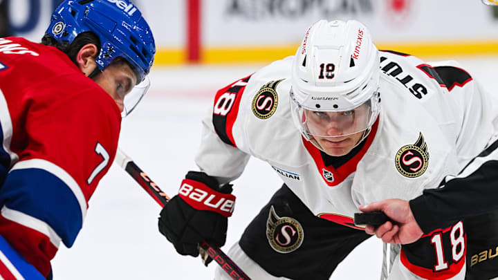 Oct 1, 2024; Montreal, Quebec, CAN; Ottawa Senators center Tim Stutzle (18) looks at the puck prior to the puck drop at face=off against Montreal Canadiens center Jake Evans (71) during the first period at Bell Centre. Mandatory Credit: David Kirouac-Imagn Images