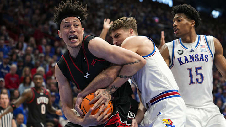 Feb 7, 2026; Lawrence, Kansas, USA; Utah Utes forward James Okonkwo (32) and Kansas Jayhawks guard Kohl Rosario (7) fight for a loose ball during the first half at Allen Fieldhouse. Mandatory Credit: Jay Biggerstaff-Imagn Images