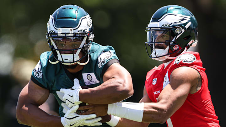 May 30, 2024; Philadelphia, PA, USA; Philadelphia Eagles quarterback Jalen Hurts (1) hands off to running back Saquon Barkley (26) during practice at NovaCare Complex. Mandatory Credit: Bill Streicher-USA TODAY Sports