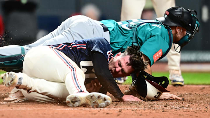 Aug 29, 2025: Cleveland Guardians right fielder Nolan Jones (22) scores under the tag of Seattle Mariners catcher Cal Raleigh (29) during the ninth inning at Progressive Field. 