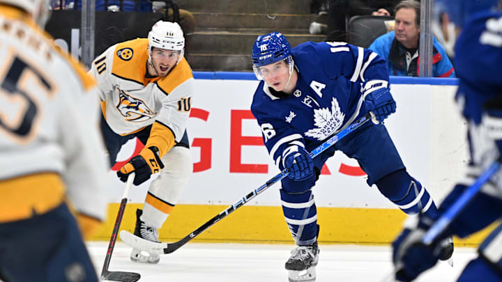 Jan 11, 2023; Toronto, Ontario, CAN; Toronto Maple Leafs forward Mitchell Marner (16) passes the puck away from Nashville Predators forward Colton Sissons (10) in the third period at Scotiabank Arena. Mandatory Credit: Dan Hamilton-Imagn Images