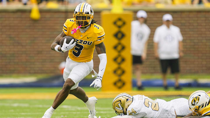 Luther Burden III leaves defenders strewn about the field as he turns upfield against Vanderbilt.