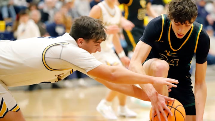 Freeport's Owen Westendorf dives to try and wrestle a loose ball away from Deer Lakes' Evan Moore during a Section 1-4A game last Friday, Dec. 12, 2025, at Freeport Middle School in Buffalo Township, Pa.