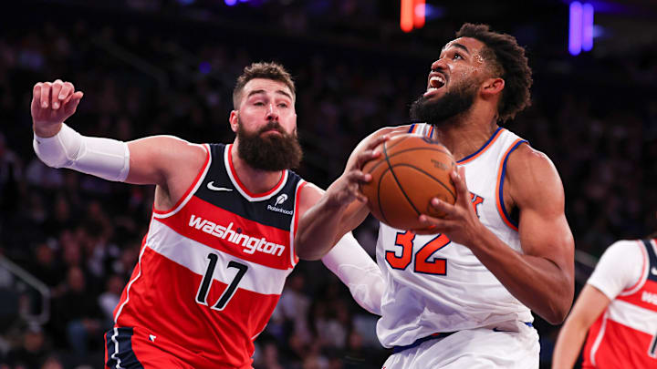 Oct 9, 2024; New York, New York, USA; New York Knicks center Karl-Anthony Towns (32) drives to the basket against Washington Wizards center Jonas Valanciunas (17) during the second half at Madison Square Garden. Mandatory Credit: Vincent Carchietta-Imagn Images