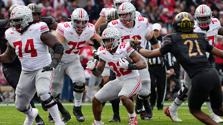 Ohio State Buckeyes running back TreVeyon Henderson (32) runs upfield during the second half of the NCAA football game at Wrigley Field in Chicago on Saturday, Nov. 16, 2024. Ohio State won 31-7.