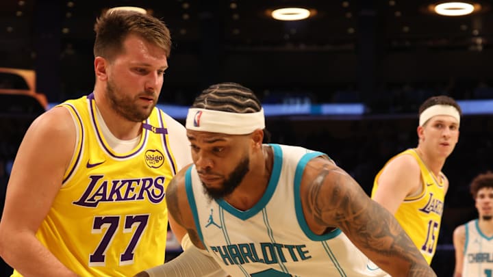 Feb 19, 2025; Los Angeles, California, USA: Charlotte Hornets forward Miles Bridges (0) drives against Los Angeles Lakers guard Luka Doncic (77) during the third quarter at Crypto.com Arena. Mandatory Credit: Jason Parkhurst-Imagn Images Feb 19, 2025; Los Angeles, California, USA: Charlotte Hornets forward Miles Bridges (0) drives against Los Angeles Lakers guard Luka Doncic (77) during the third quarter at Crypto.com Arena. Mandatory Credit: Jason Parkhurst-Imagn Images