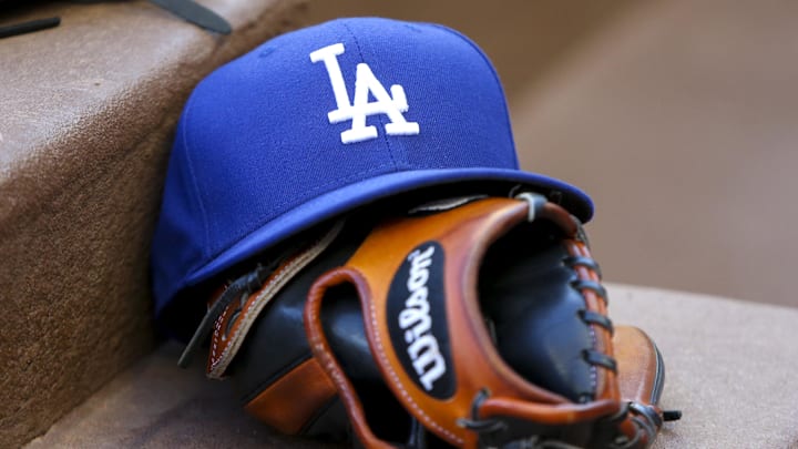 Aug 16, 2019; Atlanta, GA, USA; Detailed view of Los Angeles Dodgers hat and glove in the dugout