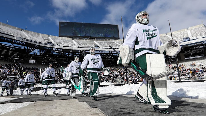 Jan 31, 2026; State College, PA, USA; Michigan State Spartans goaltender Trey Augustine (1) leads his team prior to the game against the Penn State Nittany Lions at Beaver Stadium. 