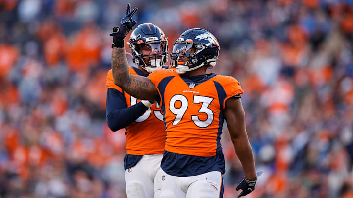 Dec 12, 2021; Denver, Colorado, USA; Denver Broncos defensive end Dre'Mont Jones (93) celebrates with linebacker Bradley Chubb (55) after a play in the third quarter against the Detroit Lions at Empower Field at Mile High. 
