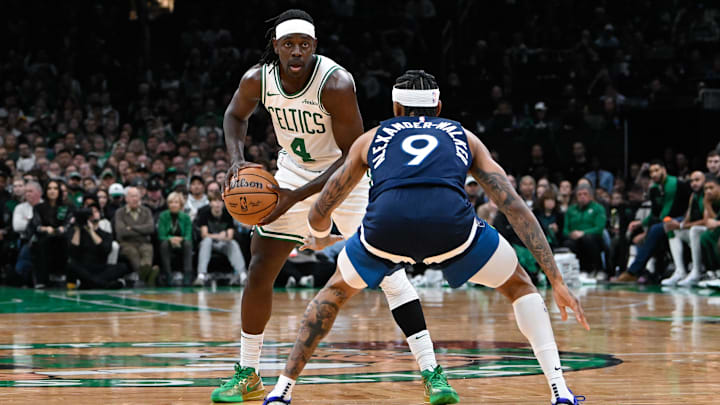 Nov 24, 2024; Boston, Massachusetts, USA; Boston Celtics guard Jrue Holiday (4) looks to pass the ball  against Minnesota Timberwolves guard Nickeil Alexander-Walker (9) during the first half at TD Garden. Mandatory Credit: Eric Canha-Imagn Images