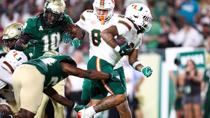 Sep 21, 2024; Tampa, Florida, USA; Miami Hurricanes running back Damien Martinez (6) score a touchdown against the South Florida Bulls in the third quarter at Raymond James Stadium. Mandatory Credit: Nathan Ray Seebeck-Imagn Images