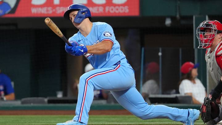 Aug 23, 2026; Arlington, Texas, USA;  Texas Rangers left fielder Wyatt Langford (36) follows through on his single against the Los Angeles Angels during the seventh inning at Globe Life Field.  Mandatory Credit: Jim Cowsert-Imagn Images