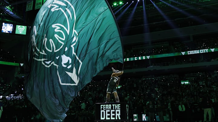 Oct 26, 2023; Milwaukee, Wisconsin, USA;  Milwaukee Bucks mascot Bango waves a flag with the Milwaukee Bucks logo prior to the game agains the Philadelphia 76ers at Fiserv Forum. Mandatory Credit: Jeff Hanisch-Imagn Images