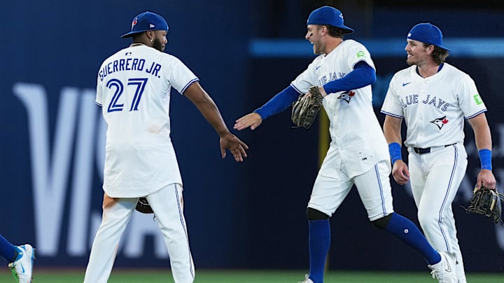 Jul 21, 2025; Toronto, Ontario, CAN; Toronto Blue Jays first baseman Vladimir Guerrero Jr. (27) celebrates the win with third baseman Ernie Clement (22) against the New York Yankees at the end of the ninth inning at Rogers Centre. 