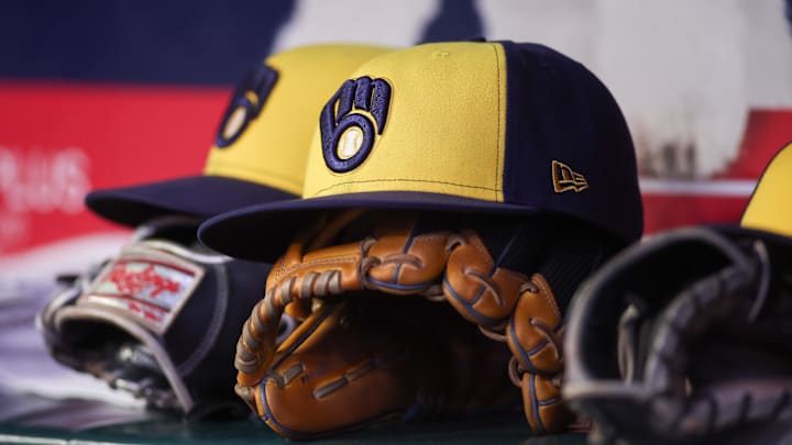 Aug 4, 2025; Atlanta, Georgia, USA; A detailed view of a Milwaukee Brewers hat and glove in the dugout against the Atlanta Braves in the fourth inning at Truist Park. Mandatory Credit: Brett Davis-Imagn Images