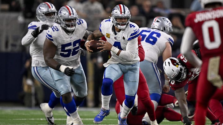 Dallas Cowboys quarterback Dak Prescott runs with the ball during the game between the Cowboys and the Arizona Cardinals.