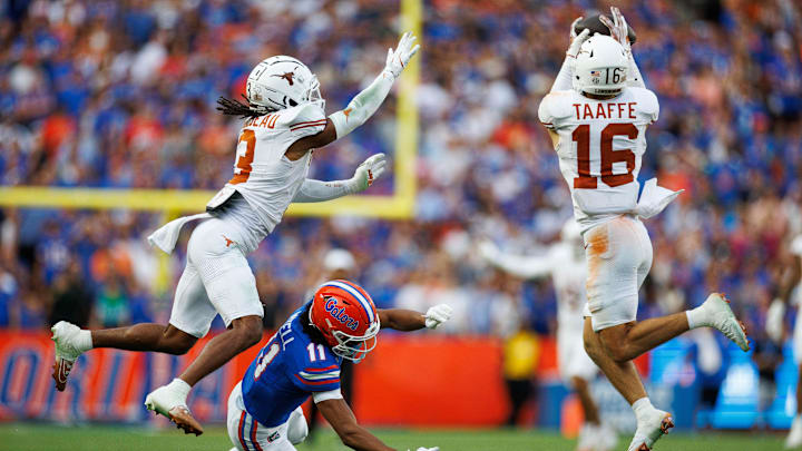 Oct 4, 2025; Gainesville, Florida, USA; Texas Longhorns defensive back Michael Taaffe (16) intercepts a pass to Florida Gators wide receiver Aidan Mizell (11) during the second half at Ben Hill Griffin Stadium. Mandatory Credit: Matt Pendleton-Imagn Images