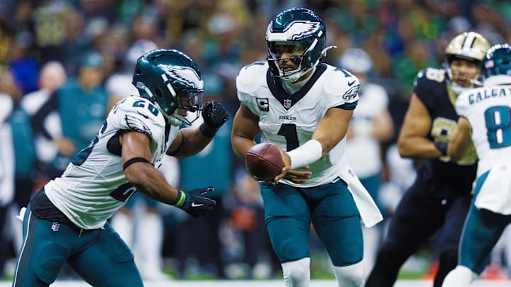 Sep 22, 2024; New Orleans, Louisiana, USA; Philadelphia Eagles quarterback Jalen Hurts (1) hands off to running back Saquon Barkley (26) against the New Orleans Saints during the second half at Caesars Superdome. Mandatory Credit: Stephen Lew-Imagn Images Sep 22, 2024; New Orleans, Louisiana, USA; Philadelphia Eagles quarterback Jalen Hurts (1) hands off to running back Saquon Barkley (26) against the New Orleans Saints during the second half at Caesars Superdome. Mandatory Credit: Stephen Lew-Imagn Images